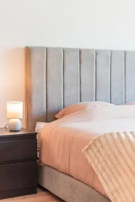 a bedroom with a bed and a lamp on a nightstand at L'Horizon - 1 BR - Pool & Terrace in Nouaseur