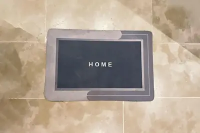 a sign that says home on a tile floor at Modern apartment with pool parking in O Ben Slimane
