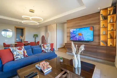 a living room with a blue couch and a table at Marina Vacation Homes in Casablanca