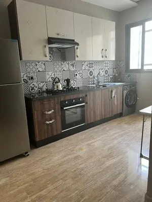 a kitchen with a sink and a stove top oven at Appartement Èlégant Vue piscine in Casablanca