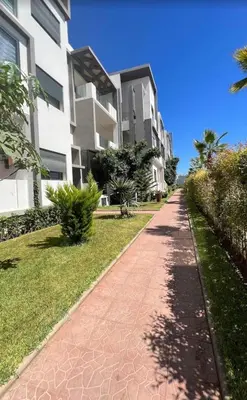 a brick path in front of a building at Appartement Èlégant Vue piscine in Casablanca