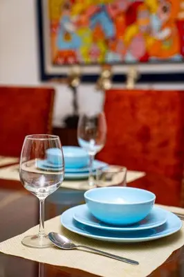 a table with plates and bowls and wine glasses at escapade de luxe face a la mer in Rabat