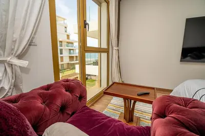 a living room with two chairs and a table at escapade de luxe face a la mer in Rabat