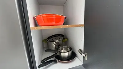 a cupboard with a pot and pans on a shelf at Between sea and historic center in Rabat