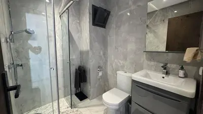 a bathroom with a shower and a toilet and a sink at Between sea and historic center in Rabat