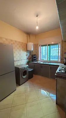 a kitchen with a washer and a sink and a refrigerator at Cozy apartment in Skhirat near Rabat in Skhirat