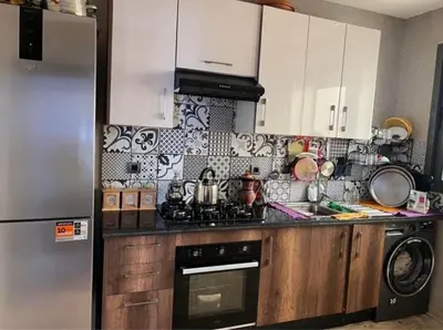 a kitchen with a refrigerator and a stove top oven at Appartement tamaris les crêtes in Casablanca