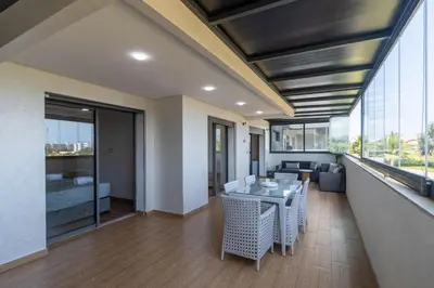 a living room with a table and a couch at Family apartment Terrace Pool Wi-Fi in O Ben Slimane