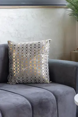 a pillow on a couch in a living room at Family apartment Terrace Pool Wi-Fi in O Ben Slimane