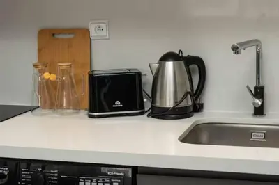 a kitchen counter with a toaster and a tea kettle at Mansouria 1BR Pool View Beach Parking in Mansouria