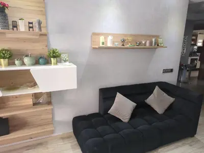 a black couch with two pillows sitting in a room at Mansbay Beach Dalia in Mohammedia