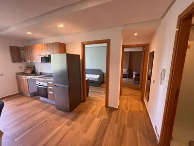 a kitchen with a stainless steel refrigerator and wooden floors at Blue Beach in Casablanca