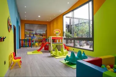 a childrens room with a play area with a playground at Elegance Pool View Apartment in Dar Bouazza