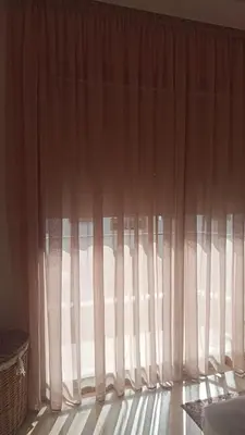 a window with white curtains in a room at Casa Comfort Apartment in Casablanca
