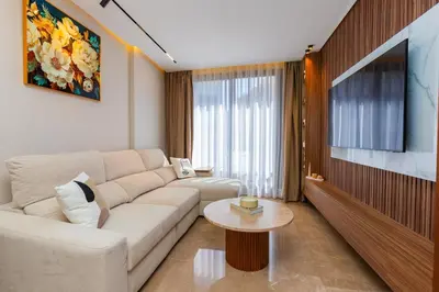 a living room with a white couch and a tv at Cozy and new apartment in Princesses in Casablanca