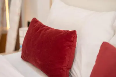 a red pillow sitting on top of a bed at Awesome place with city view maarif casablanca in Maarif