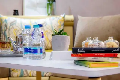a table with bottles of water and books on it at Centre rabat agdal 10min of stade molay aabdellah in Rabat