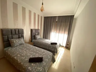 a hotel room with two beds and a window at Bourgogne Ocean Prestige in Casablanca