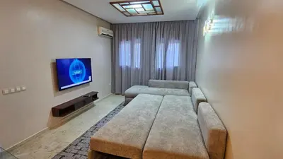a living room with a couch and a flat screen tv at Modern and cozy - Central apartment in Casablanca in Casablanca
