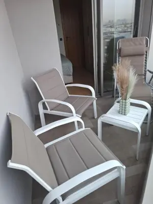 a group of chairs and a table in a room at Luxurious and cozy CFC panoramic view studio in Casablanca