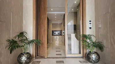 a hallway with two potted plants in a building at Spacious 3-Bedroom Apartment in Maarif, Premium Comfort for Families, Groups & Business Travelers in Casablanca