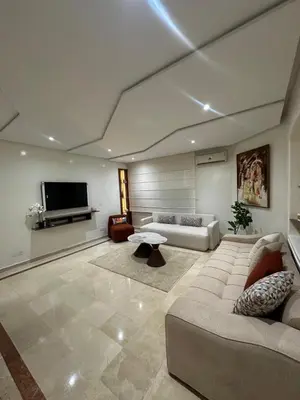 a living room with a couch and a flat screen tv at Cozy stylish Studio in downtown Casablanca in Casablanca