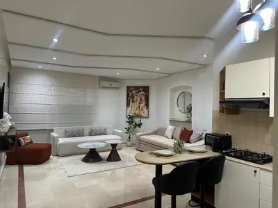 a living room with a couch and a table at Cozy stylish Studio in downtown Casablanca in Casablanca