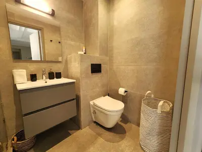 a bathroom with a toilet and a sink and a mirror at The 41 Maarif by IB Signature - Boho Chic 1BR Apt - with Wifi - Self check-in - 24 x7 Security - City View with terrace - Walk to Cafes! City Centre in Casablanca