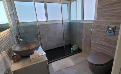 a bathroom with a shower and a sink and a toilet at Bel Appartement Spacieux et Lumineux Maarif in Casablanca