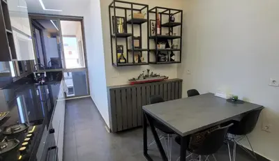 a kitchen with a table and a dining room at Bel Appartement Spacieux et Lumineux Maarif in Casablanca