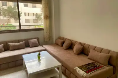 a living room with a couch and a table at Appartement Moderne Équipé Proche Aéroport Mohammed V in Nouaseur