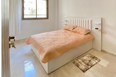 a bedroom with a bed and a window at Appartement Moderne Équipé Proche Aéroport Mohammed V in Nouaseur