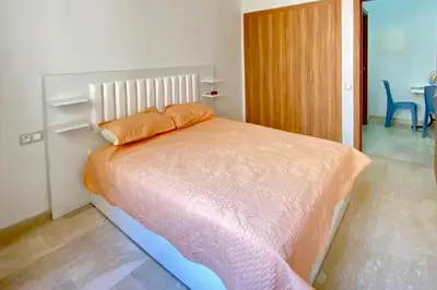 a bedroom with a bed with two pillows on it at Appartement Moderne Équipé Proche Aéroport Mohammed V in Nouaseur