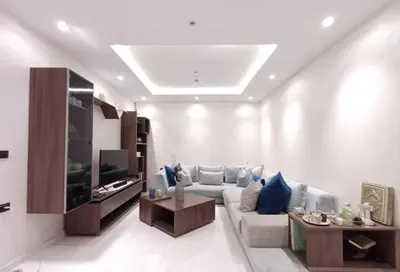 a living room with a couch and a tv at Prestigious apartment Elegant and refined in Casablanca