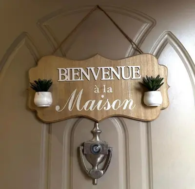 a wooden sign that says beware a maessor on a door at Prestigious apartment Elegant and refined in Casablanca