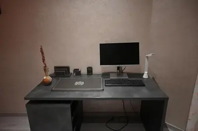 a desk with a computer monitor and a keyboard at Prestigious apartment Elegant and refined in Casablanca