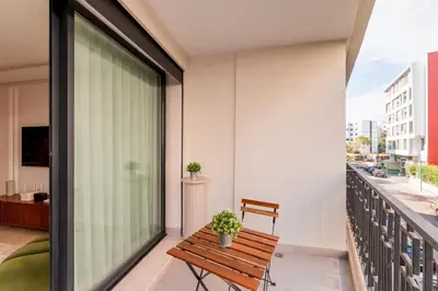 a balcony with a wooden bench on a building at Chic Hotel-Style Apartment in Casablanca in Casablanca