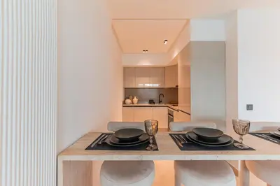 a kitchen and dining room with a table and chairs at Chic Hotel-Style Apartment in Casablanca in Casablanca