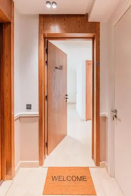 a door to a hallway with a welcome mat on the floor at Chic Hotel-Style Apartment in Casablanca in Casablanca