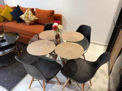 a living room with a glass table and chairs at Studio Le plus Beau Casablanca in Casablanca