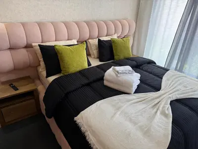 a bedroom with a large bed with a pink headboard at Studio Le plus Beau Casablanca in Casablanca
