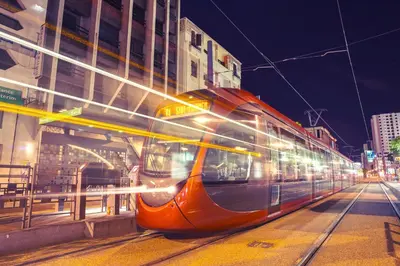 a train on a city street at night at Studio Le plus Beau Casablanca in Casablanca