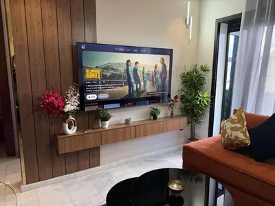 a living room with a flat screen tv on a wall at Studio Le plus Beau Casablanca in Casablanca