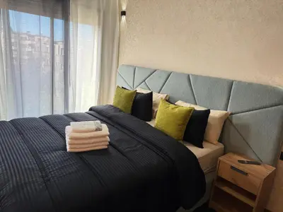 a bedroom with a large bed with a large window at Studio Best in Casablanca in Casablanca