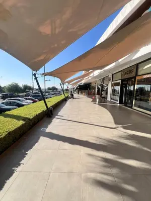 a large canopy over a sidewalk in a parking lot at Luxury Stay in Prestigia Golf City in Bouskoura