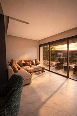 a living room with two couches and a large window at Luxury Stay in Prestigia Golf City in Bouskoura