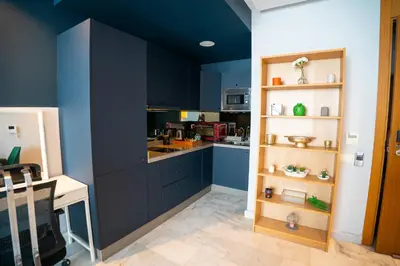 a kitchen with blue walls and a counter top at Cedar Stays Studio apartment 1chambre salon - WiFi - climatisation - parking - machine a laver- 5 min CFC in Casablanca