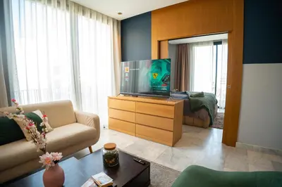 a living room with a television on a dresser at Cedar Stays Studio apartment 1chambre salon - WiFi - climatisation - parking - machine a laver- 5 min CFC in Casablanca