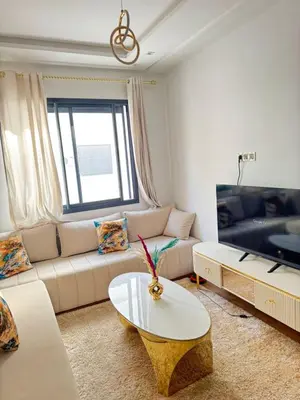 a living room with a couch and a table at Appartement de luxe in Casablanca