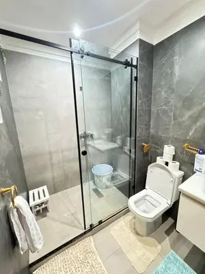 a bathroom with a shower and a toilet and a sink at Appartement de luxe in Casablanca